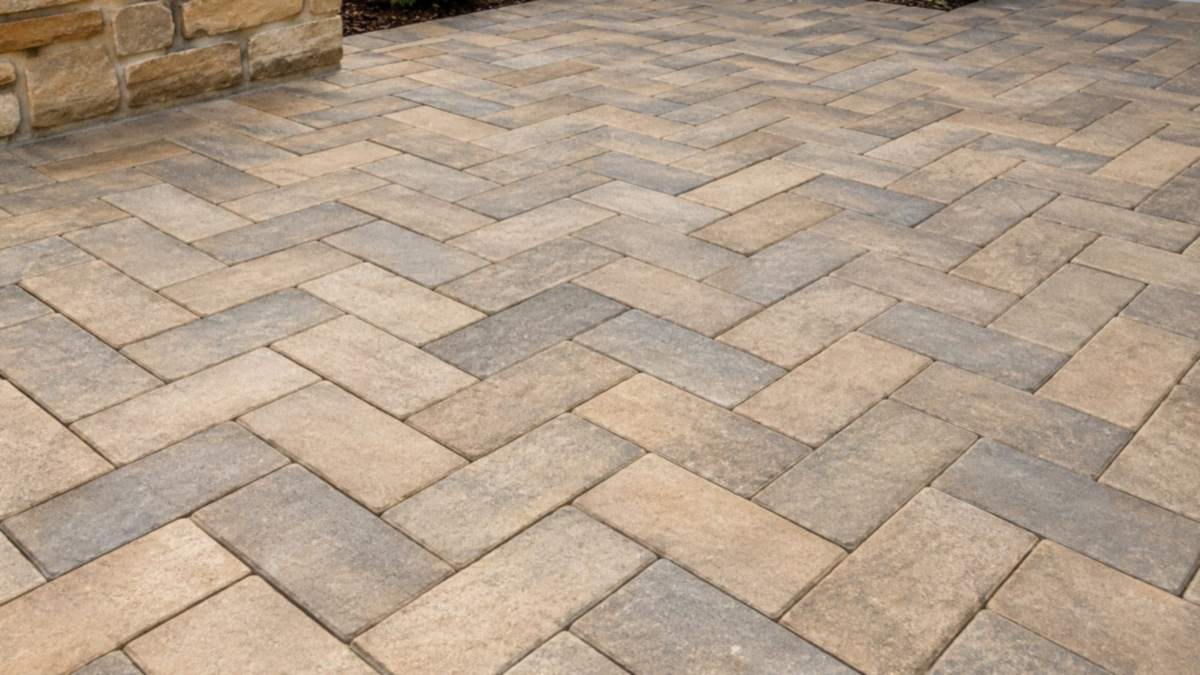 Herringbone paved courtyard in sand and grey tones