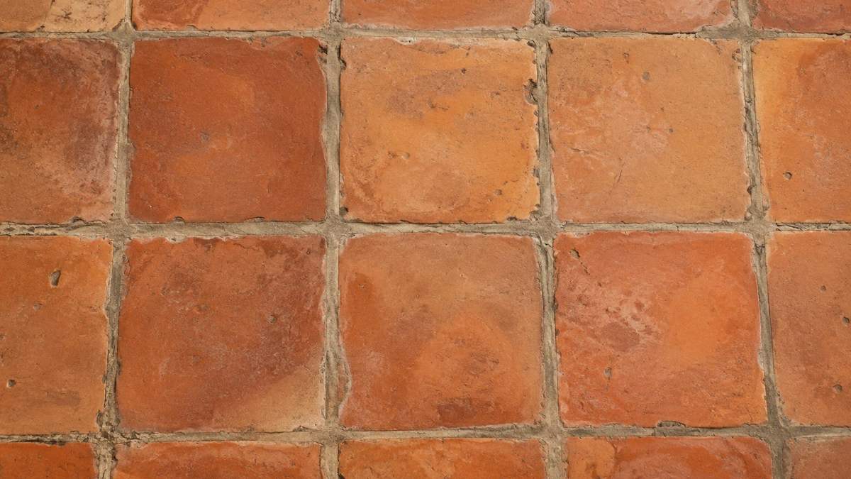 Rustic orange Saltillo tile floor with wide grout joints