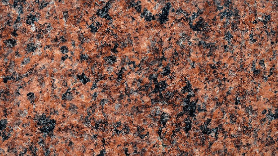 Close-up of red and black speckled granite