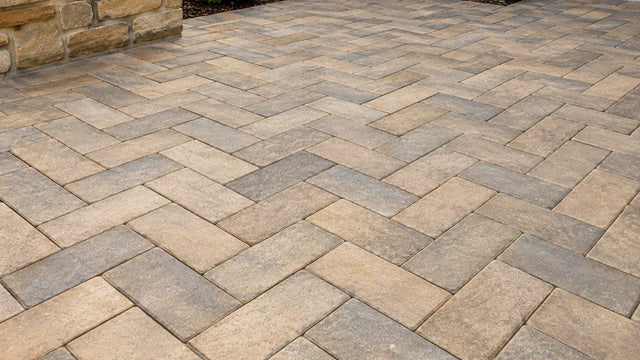 Herringbone paved courtyard in sand and grey tones