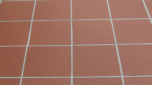 Unglazed red quarry tile floor with light grout lines